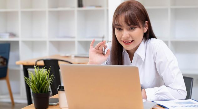 Smiling beautiful woman using digital tablet at home