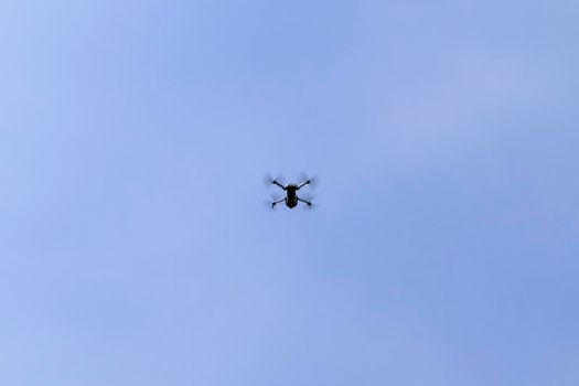 quadrocopter in flight against the blue sky. High quality photo