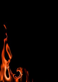 Flames of fire on a black background. Space for copy, text, your words. Vertical