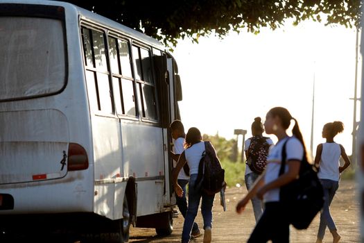 santo antonio de jesus, bahia, brazil - august 7, 2019: public school students are seen along the school transport bus in the street area in the city of Santo Antonio de Jesus.