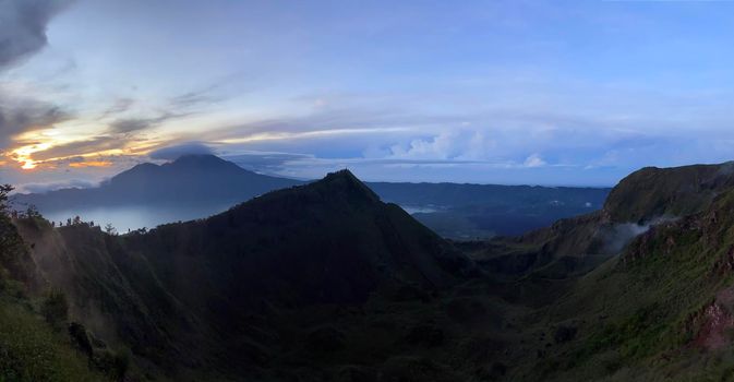 Hiking around the crater of Mount Batur with Mount Agung in the background