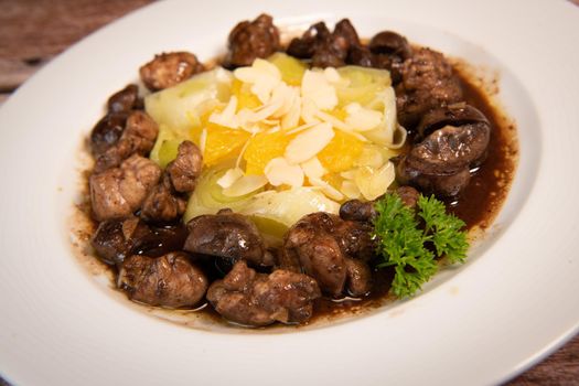 Recipe of sweetbread and lamb kidney with cocoa, leek whistles with almonds and oranges. High quality photo