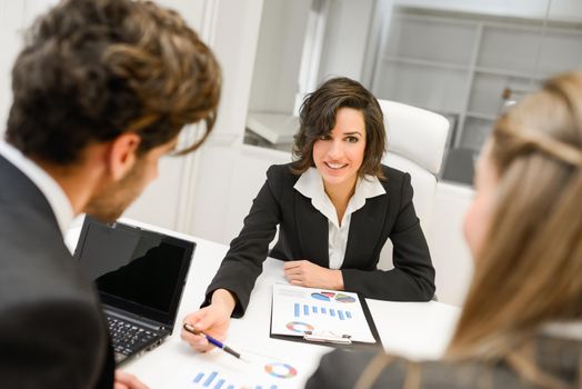 Image of business partners discussing documents and ideas at meeting