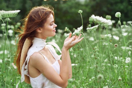 pretty woman in white dress in a field flowers nature. High quality photo