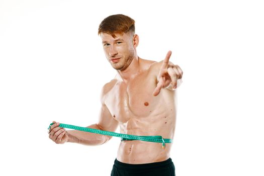 athletic man with measuring tape muscle workout. High quality photo