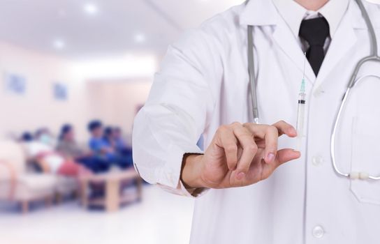 doctor holding syringe in hospital background