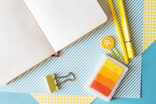 School supplies. Yellow and blue colors. Empty notebook. Flat lay composition. Space for text. Back to school.