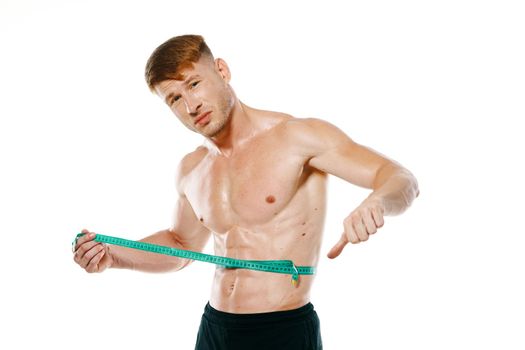 athletic man with measuring tape muscle workout. High quality photo