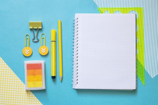 School supplies. Yellow and blue colors. Empty notebook. Flat lay composition. Space for text. Back to school.