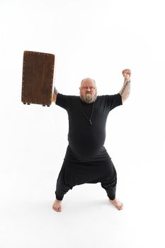 Funn caucasian bearded tattoed man is posing on white background