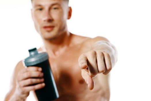 athletic man with a pumped-up torso drink bottle sportspit. High quality photo