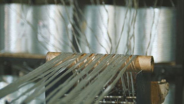 Producing fiberglass rods - manufacture of composite reinforcement, industry for construction, close up