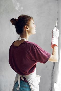 woman paints house renovation interior room painter. High quality photo