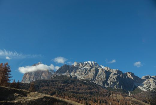 Dolomites nature. A view on mountains and blue sky. Mid shot