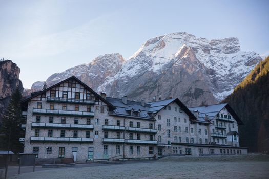 Dolomites. A beautiful house with a huge mountains on a background. Mid shot