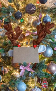 Christmas mail envelope with blank letter in decorated tree with reindeer ears for copy space close to, background, Holiday concept space for text