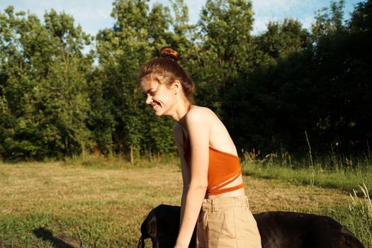 Cheerful Woman and a dog in the nature games Friendship. High quality photo