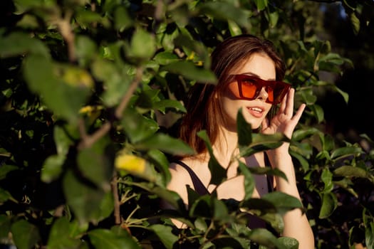 pretty woman wearing sunglasses green leaves glamor posing summer. High quality photo