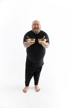 Funn caucasian bearded tattoed man is posing on white background