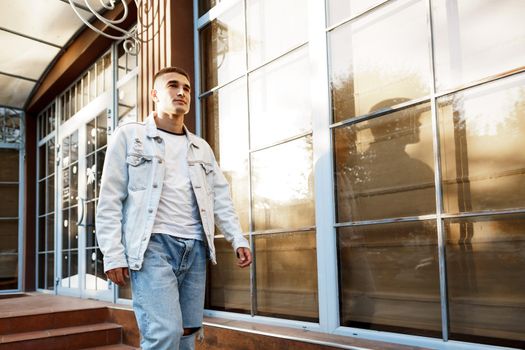 Portrait of handsome young casual man walking on the city street