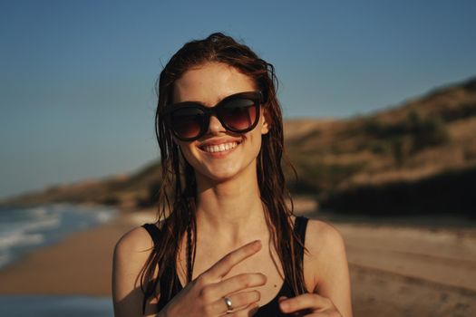 pretty woman in black swimsuit beach nature sun. High quality photo