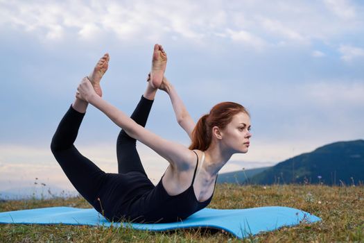 sportive woman workout meditation in the mountains outdoors. High quality photo