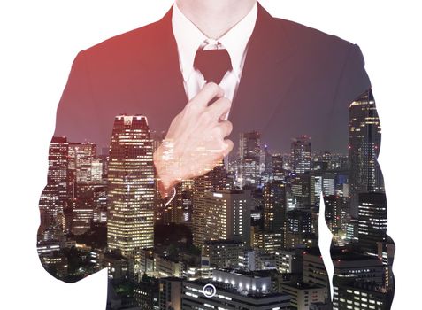 Double exposure of Businessman in suit tying the necktie against the city isolated on white background