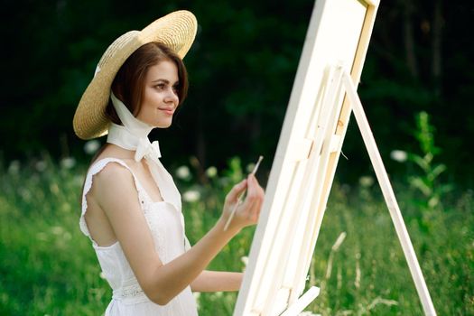 Woman in white dress artist hobby nature landscape. High quality photo