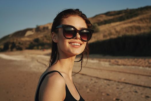 woman on the beach in sunglasses in a swimsuit sun. High quality photo