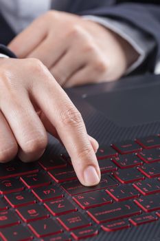 finger pushing enter button on a laptop keyboard