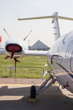 An outdoors airplane exposition - an airplane with strange things on the wing. Mid shot