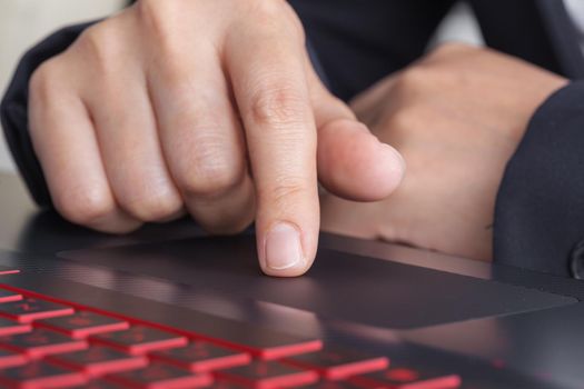 business hand working on a laptop of touchpad