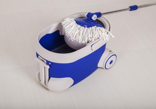 mop and blue bucket for cleaning the floor