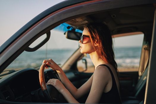 pretty woman in sunglasses driving a car trip. High quality photo
