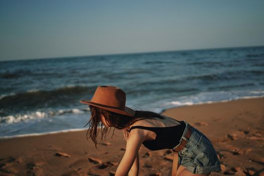 pretty woman in hat walking on the beach ocean travel. High quality photo