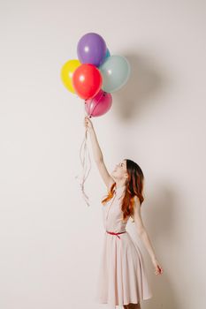 cheerful woman in a dress of colorful balloons. High quality photo