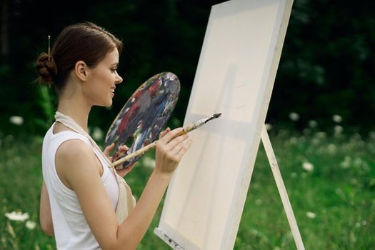 woman outdoors paint a picture landscape hobby creative. High quality photo