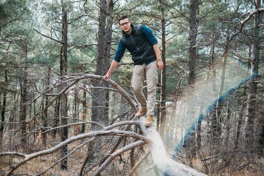 Traveler explorer young man walking in the forest