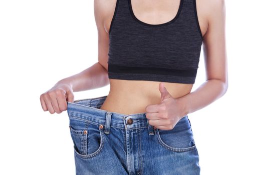 close up slim woman in old jeans showing thumbs up isolated on a white background