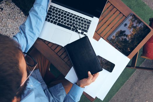 business man in cafe with laptop working outdoors. High quality photo