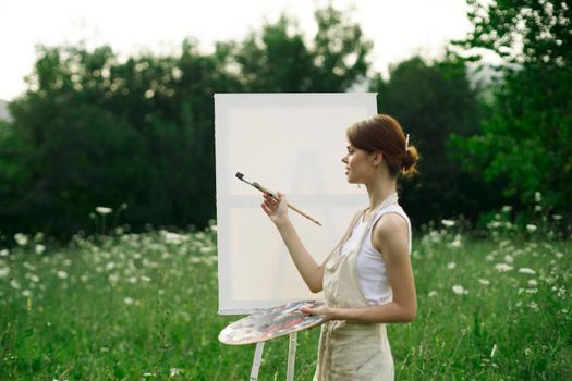 woman artist outdoors easel drawing creative landscape. High quality photo