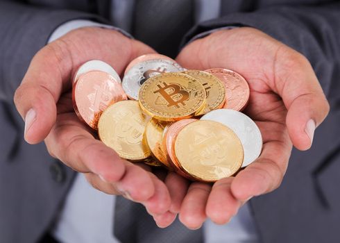 bitcoin in hand of business man with suit