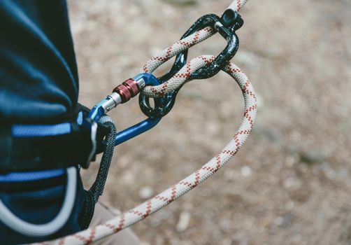 Female climber in harness with rope and figure eight.