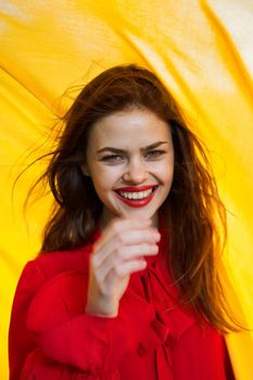 cheerful woman in red dress makeup yellow cloth posing. High quality photo