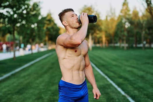 male athlete with pumped up body in parks crossfit workout. High quality photo