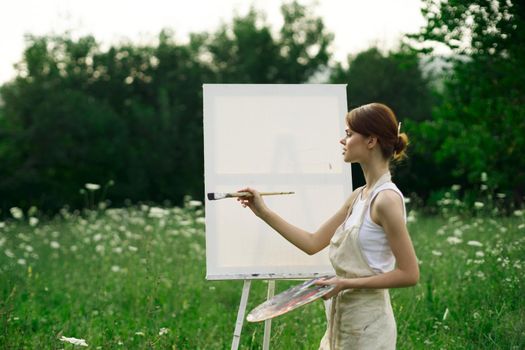 woman artist outdoors easel drawing creative landscape. High quality photo