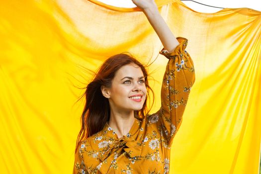 cheerful woman gesturing with her hands yellow background. High quality photo