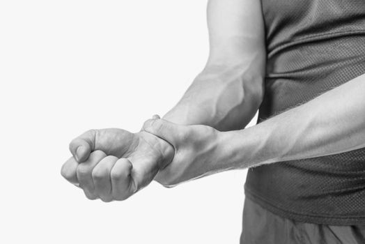 Pain in a male wrist. Man holding his hand. Monochrome image, isolated on a white background.