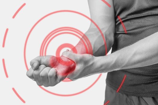 Acute pain in a male wrist. Man holding his hand. Monochrome image, isolated on a white background. Pain area of red color.