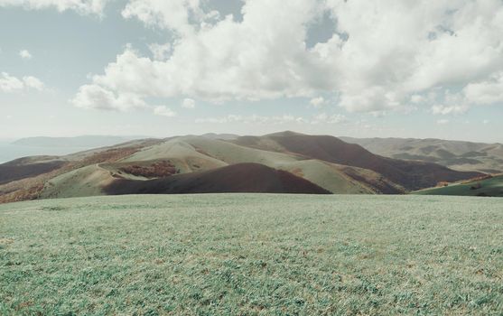 Beautiful mountain ridge landscape and clouds in sky in summer season.